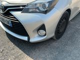 a silver toyota yaris parked on the side of the road
