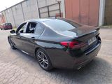 the rear end of a black bmw sedan parked in a parking lot