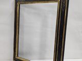 a black and gold framed mirror on a white background