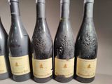 six bottles of wine are lined up on a table