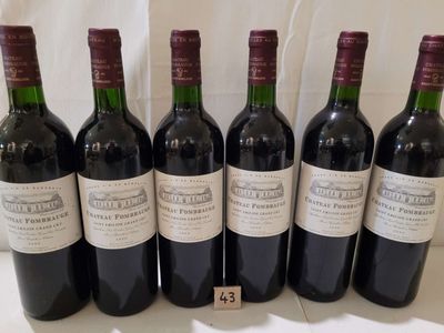 six bottles of wine are lined up in a row on a table