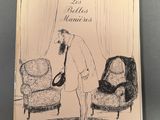 un vieux livre sur lequel figure le dessin d'un homme debout dans un salon