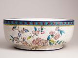 a white bowl with blue and red designs on it