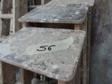 two tables that have numbers on them in front of a building