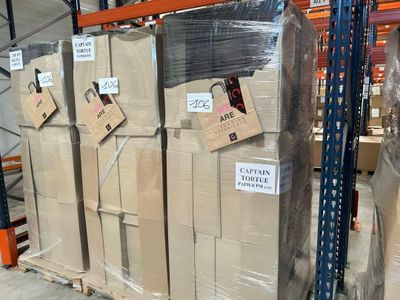 une grande pile de cartons sur une palette dans un entrepôt