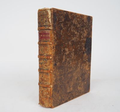 an old book sitting on top of a white surface
