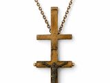 a wooden cross on a chain on a white background
