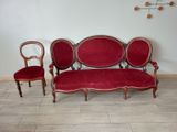a red couch and two chairs in a room