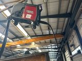 a crane that is hanging from the ceiling of a building