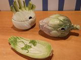 three vegetables that are sitting on a wooden table