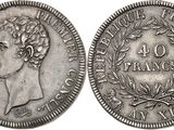 a silver coin with a woman ' s head and laurels on it