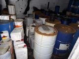 many barrels of different sizes and colors in a room