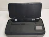 a black printer sitting on top of a white table