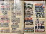 an open book with stamps on it sitting on a table