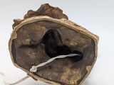an image of a sculpture of a shell with a cord attached to it