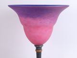 purple and blue glass vase with a wooden base