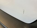 a close up of a white sink on a black counter