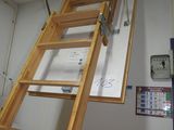 a wooden ladder that is attached to a wall