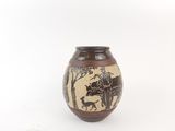 a brown vase with a black and white design on it