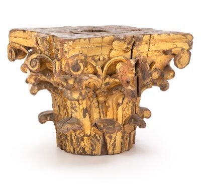 a wooden pedestal with carvings on it on a white surface