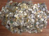 a pile of coins sitting on a wooden table