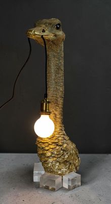 une lampe en forme d'autruche avec une ampoule fixée sur sa tête