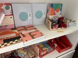 a white shelf with books and other office supplies on it