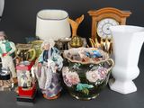 many different vases and figurines sitting on a table