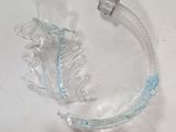 a glass sculpture of a fish on a white surface