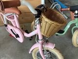 a pink bike with a basket on the back