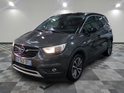 the grey opel is parked in a large room with a checkered floor