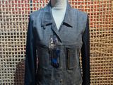 denim jacket with leather sleeves and tassels on a mannequin dummy