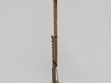 a wooden floor lamp with a white shade on top of it