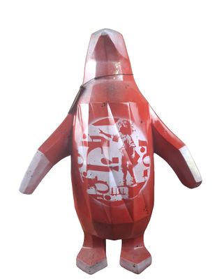 an inflatable red penguin with a hoodie on its head