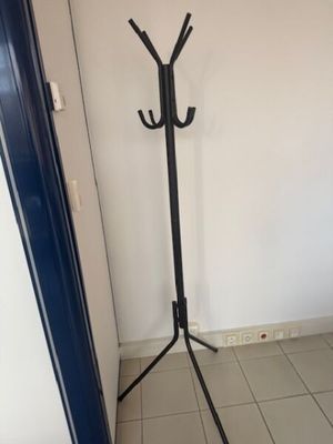 an image of a coat rack in the corner of a room