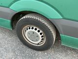 a green van that is parked on the side of the road