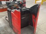 the forklift is parked in the warehouse with the door open