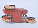 a red toy motorcycle with a basket on the back of it