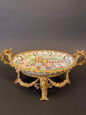 an ornately decorated tray with a clock on it