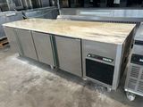 a counter with a bunch of food on it in a kitchen