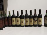 several bottles of wine are lined up in a row on a table