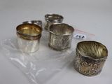 three silver cups sitting on top of a plastic bag next to each other