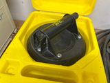 a yellow box with a black handle in it