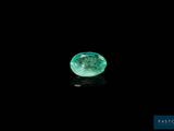 a close up of a green diamond on a black surface