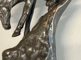 a statue of a horse and a giraffe on a table