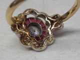 a gold ring with a pink stone in the center