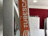 a close up of a metal door handle with a red sticker on it
