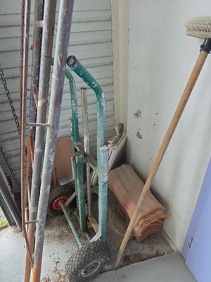 a lot of tools that are sitting outside of a house