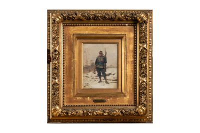 une vieille photo d'un homme debout dans la neige, dans un cadre doré