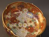 an image of a small bowl with flowers on it on a table